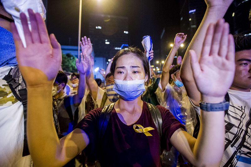 Una manifestante muestras sus manos a la Policía