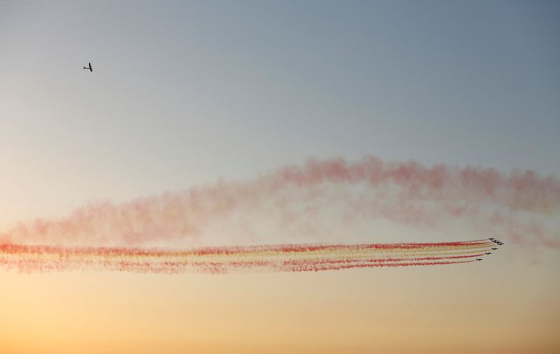 Solar Impulse 2 flies over Spanish air force aerobatic team Patrulla Aguila before landing at San Pablo airport in Seville, southern Spain