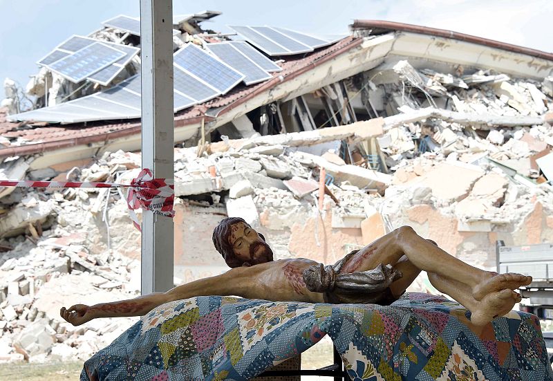 A statue of Jesus lies on a table prior to funeral for victims of earthquake at Amatrice