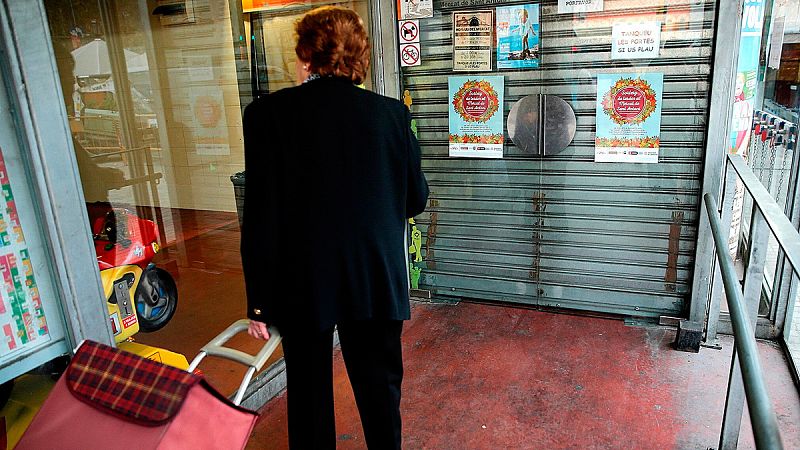Una mujer ante las puertas del Mercado de Sant Antoni