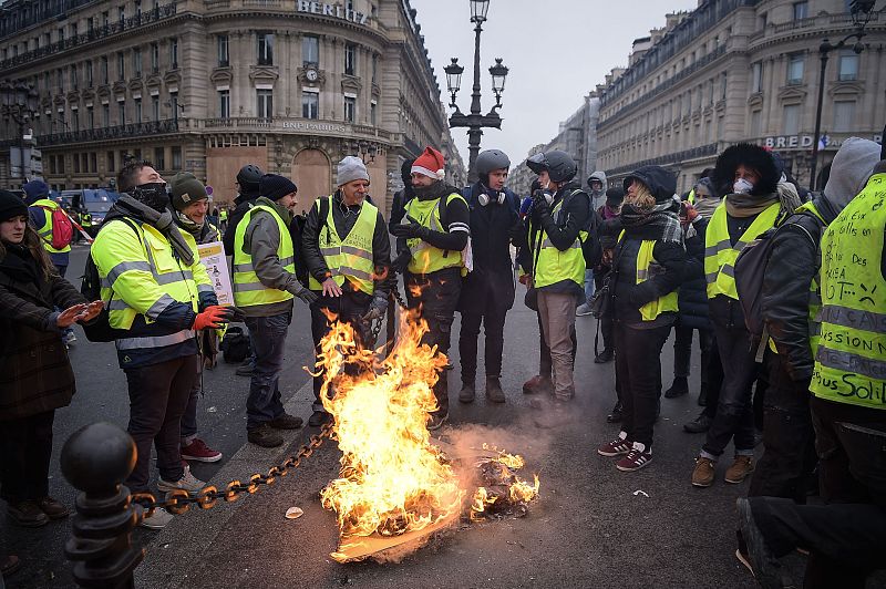 Un grupo de manifestantes se calienta las manos en una fogata
