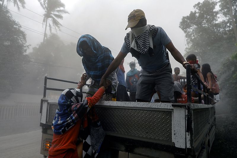 Residents living near the erupting Taal Volcano evacuate from Lemery