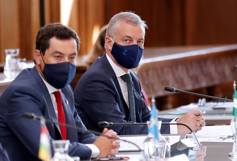 El lendakari Íñigo Urkullu (d) junto al presidente de Andalucía, Juanma Moreno. El lehendakari ha aparecido casi por sorpresa en la conferencia, después de descartar su presencia el jueves. Urkullu acude tras pactar sobre deuda y déficit vascos.