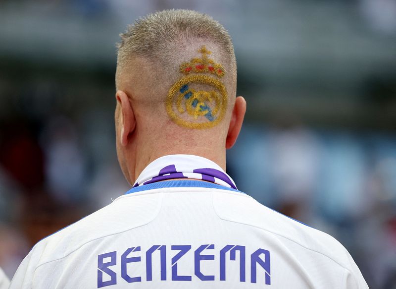 Un aficionado del Real Madrid luce el escudo de su equipo en su cabeza.