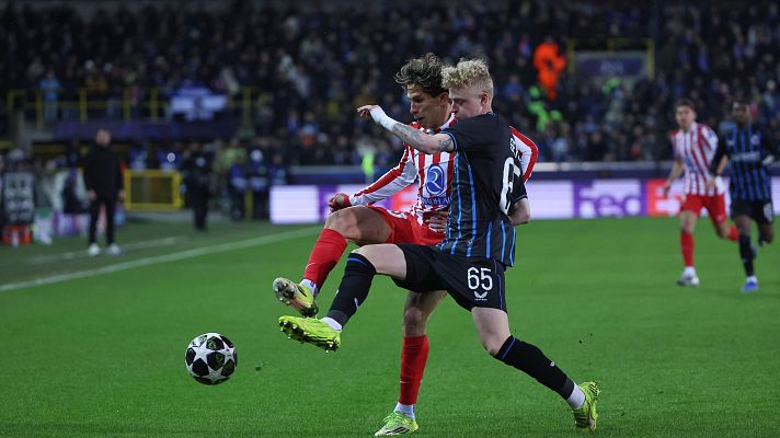 Brugge's Joaquin Seys, right, and Atletico Madrid's Giuliano Simeone challenge for the ball dueing the Champions League play-off first leg soccer match between Club Brugge and Atletico Madrid, in Bruges, Belgium, Wednesday, Feb. 18, 2026. (AP Photo/Omar Havana)