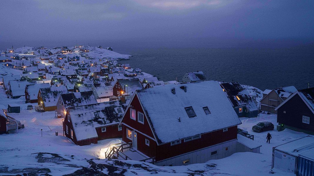 Houses covered by snow are seen on the coast of a sea inlet of Nuuk, Greenland, on Monday, Jan. 12, 2026. (AP Photo/Evgeniy Maloletka)