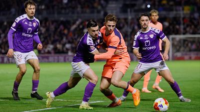 Barcelona's Fermin Lopez, center, duels for the balls with Guadalajara's Miguell Cera, second left, during the Copa del Rey soccer match between Guadalajara and Barcelona in Guadalajara, Spain, Tuesday, Dec. 16, 2025. (AP Photo/Rudy Garcia)
