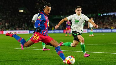 Barcelona's Jules Kounde, left, vies for the ball with Racing Santander's Mario Garcia during the Copa del Rey round of 16 soccer match between Racing Santander and Barcelona, in Santander, Spain, Thursday, Jan. 15, 2026. (AP Photo/Miguel Oses)