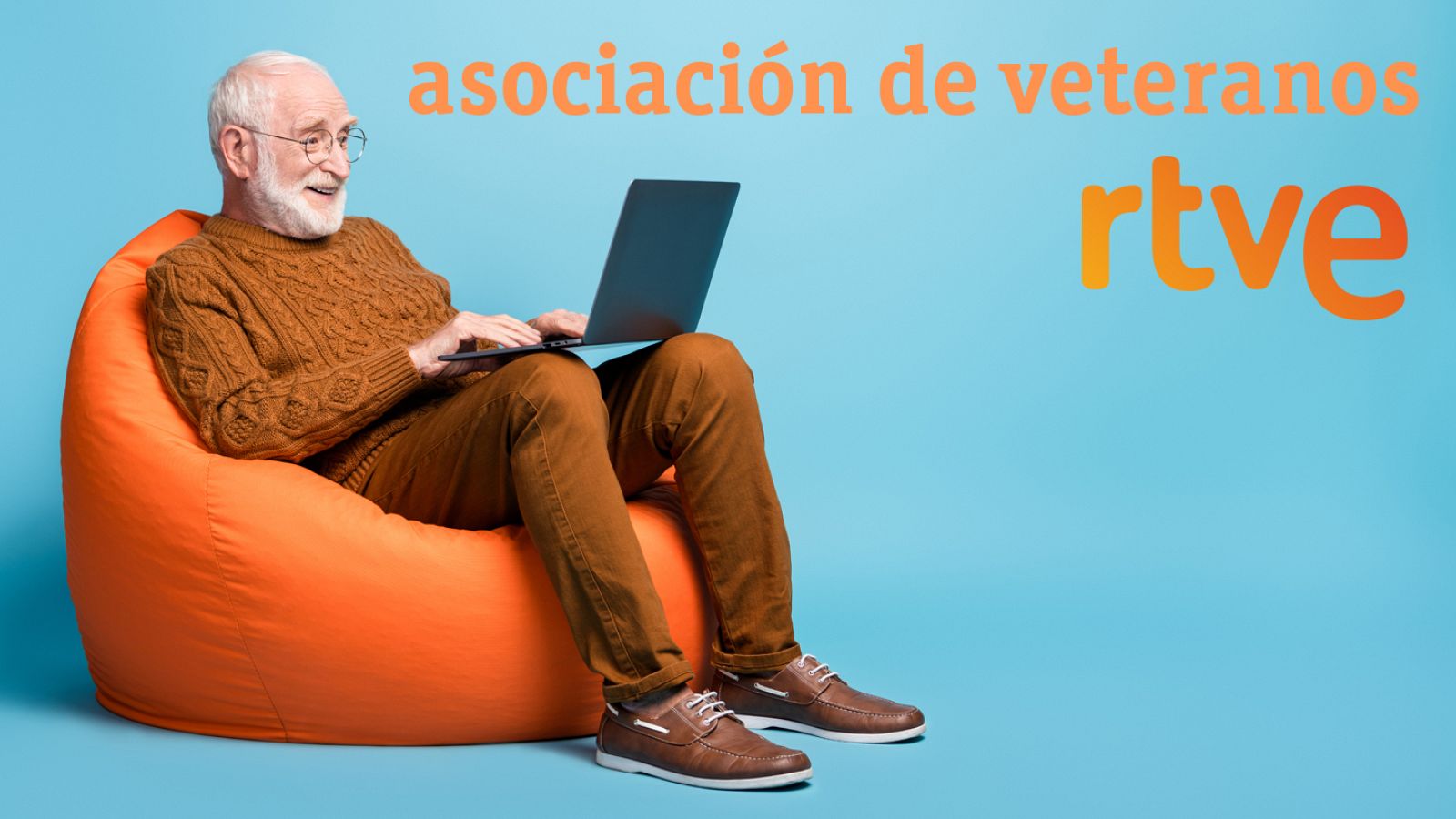 Portrait of his he nice attractive focused bearded grey-haired man sitting in bag chair using laptop writing email letter browsing web wi-fi isolated over blue pastel color background