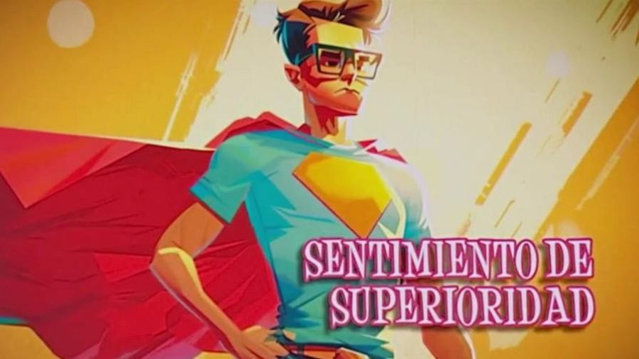 Superhéroe con capa roja y símbolo amarillo en camiseta azul, gafas. Texto: "SENTIMIENTO DE SUPERIORIDAD". Fondo anaranjado.