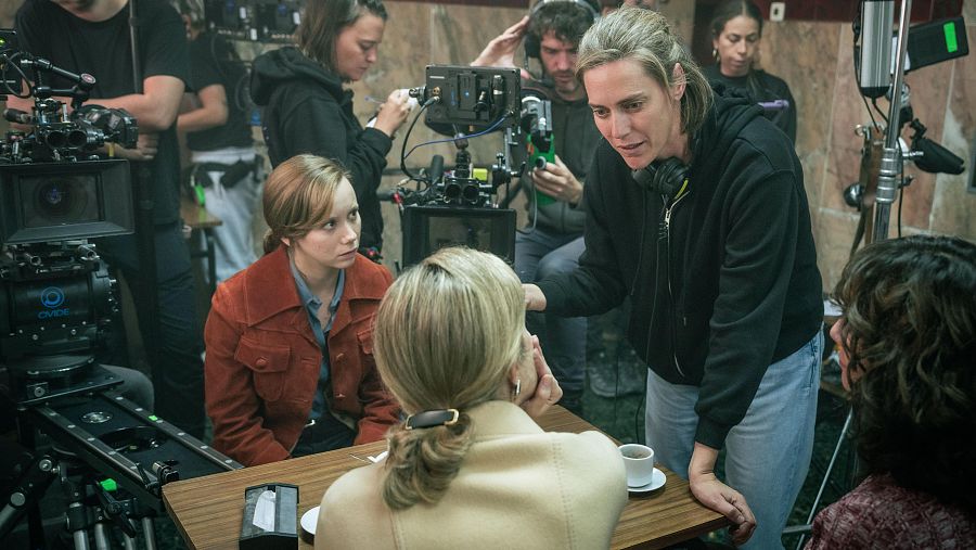 Rodaje de escena interior: tres actrices en una mesa, una directora con auriculares les da indicaciones.  Cámaras y micrófonos presentes.