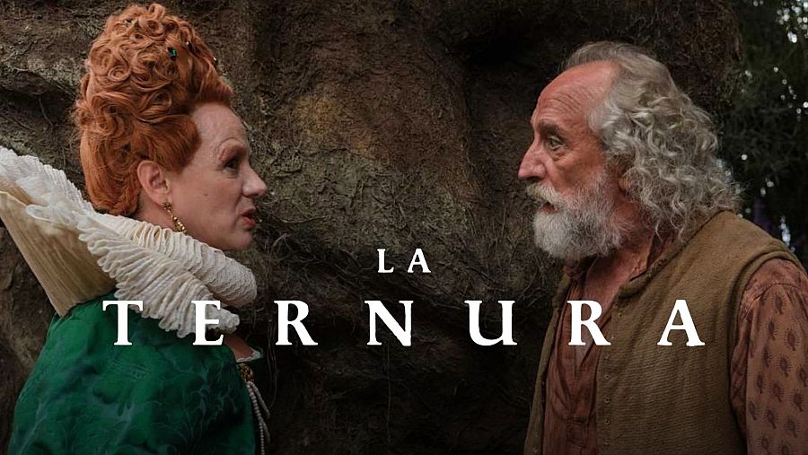 En primer plano, una mujer con peinado pelirrojo y vestido verde, junto a un hombre con barba y ropa marrón, se miran de perfil. El título de la película se muestra en letras blancas.