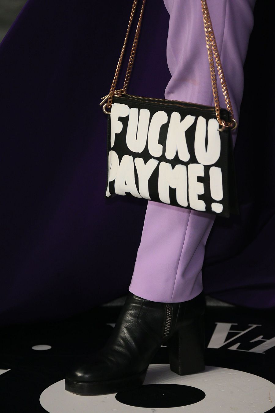 Detalle del bolso de Billy Porter que reza "Que os den, pagadme"