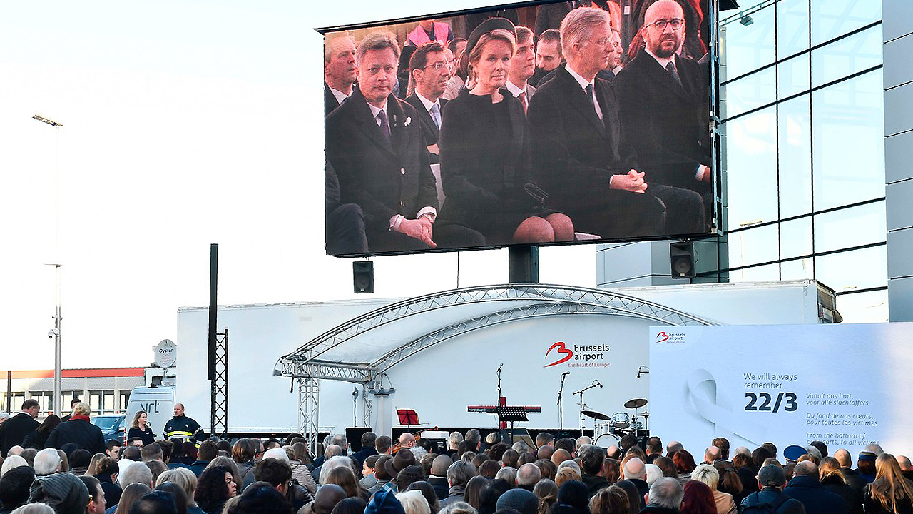 Aniversario de los atentados en Bruselas Los reyes de los belgas, Matilde y Felipe, y el primer ministro Charles Michel, en la pantalla durante la ceremonia de recuerdo a las víctimas de los atentados de Bruselas en el aeropuerto de Zaventem
