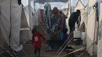 Una mujer y un nio en el campo de refugiados palestinos de Yarmuk en Siria