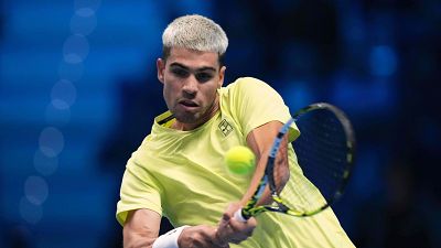 Spain's Carlos Alcaraz returns the ball to Australia's Alex de Minaur during their singles tennis match of the ATP World Tour Finals, in Turin, Italy, Sunday, Nov. 9, 2025. (AP Photo/Antonio Calanni)