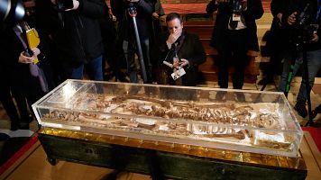 Journalists record the remains of Francis of Assisi inside the Basilica of St. Francis of Assisi in Assisi, Italy, Saturday, Feb. 21, 2026, on the eve of a public exposition beginning Feb. 22 to mark the 800th anniversary of his death in 1226.  (AP Photo/Gregorio Borgia)