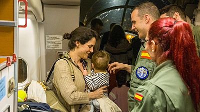 Una mujer y su beb� a la llegada a Madrid de los pasajeros evacuados desde Om�n