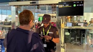 Agents de policia revisen la documentaci� dels passatgers d'un vol procedent de Mil� a l'Aeroport del Prat