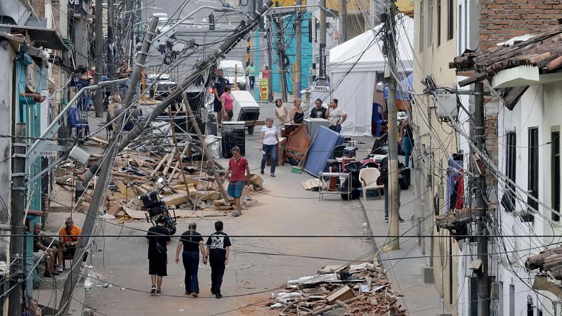 Personas caminan frente a edificaciones afectadas por el terremoto de magnitud 7,4, este viernes en Pereira (Colombia).