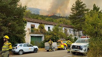 Bomberos protegiendo viviendas en el incendio forestal de Riglos