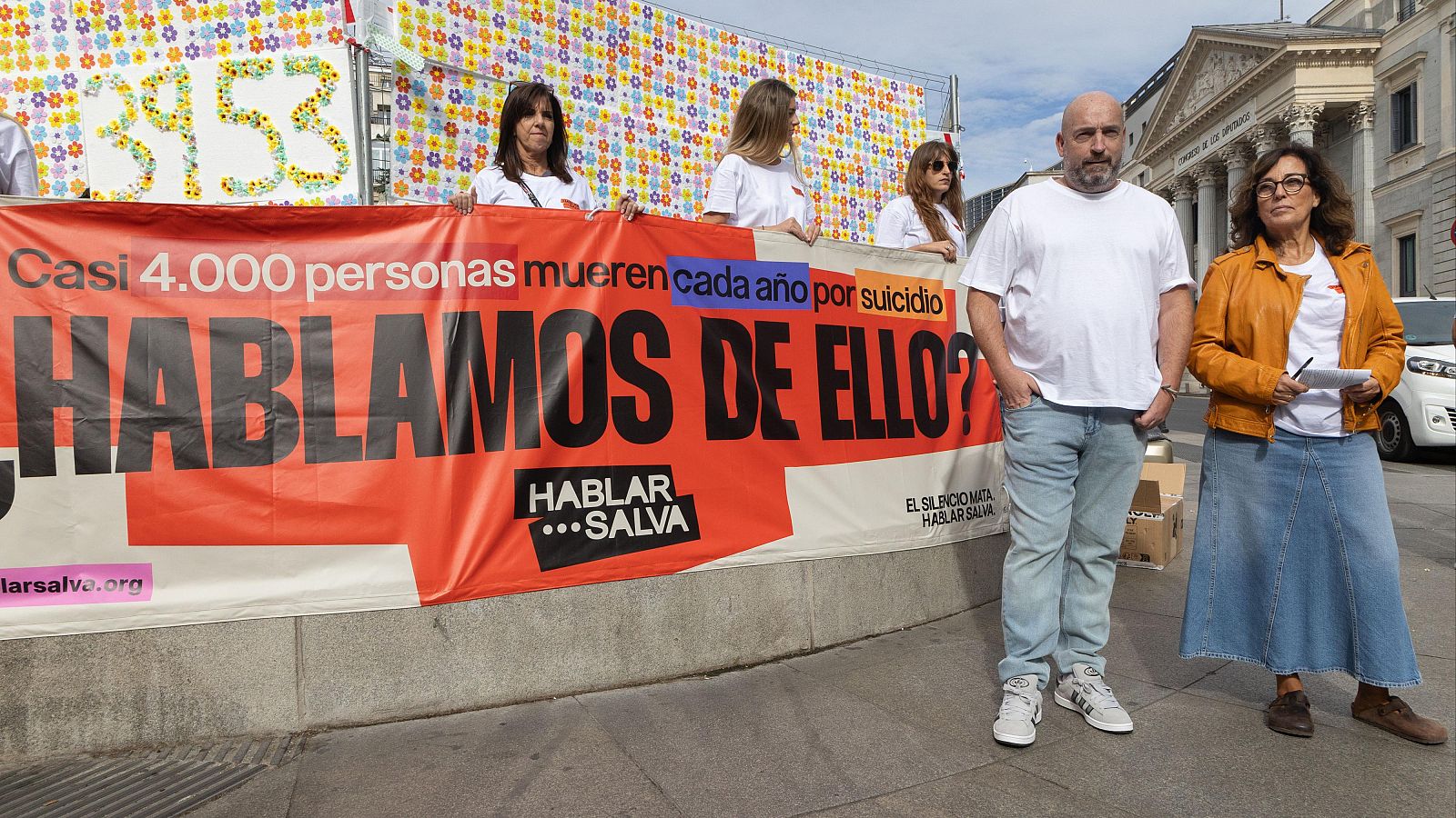 José Manuel López y Vicky Nieto, familiares de víctimas de suicidio, participan en la colocación de 3.953 flores en recuerdo de las personas fallecidas por suicidio, frente al Congreso