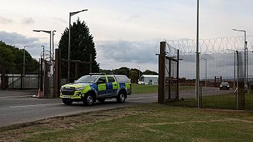 Un coche patrulla sale de la base a�rea de RAF Molesworth despu�s de que dos ciudadanos letones fueran arrestados