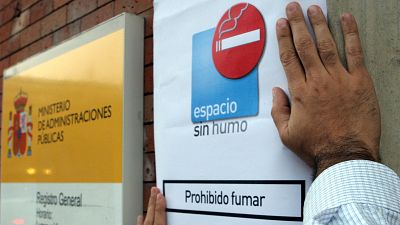 Colocación de un cartel de prohibido fumar por la entrada en vigor de la ley antitabaco en 2006