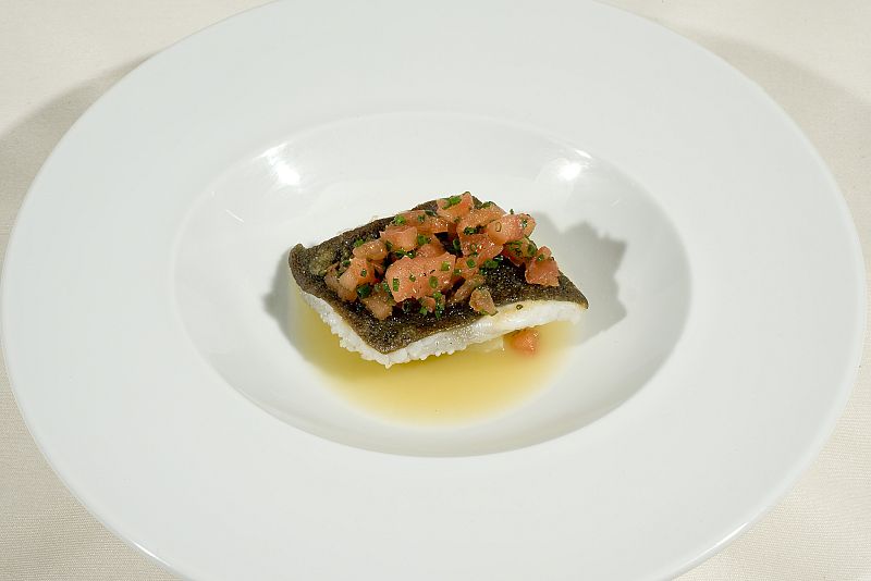 Rodaballo con tartar de tomate, patatas confitadas y jugo de almejas