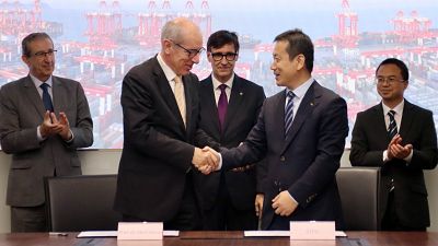 Convenio entre el Port de Barcelona y el Port de Shanghai. Sus presidentes se dan la mano, rodeados de asistentes en traje que aplauden. Ambiente formal. Convenio entre el Port de Barcelona y el Port de Shanghai. Sus presidentes se dan la mano, rodeados de asistentes en traje que aplauden. Ambiente formal.