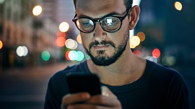 Una persona detiene su navegación en el móvil para contrastar información en un entorno digital complejo