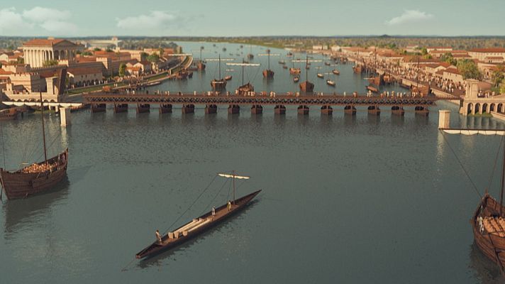Ciudad antigua junto a un río, con puente de arcos y barcos; uno grande cargado y otro pequeño con vela y tripulantes. Arquitectura de piedra y columnas.