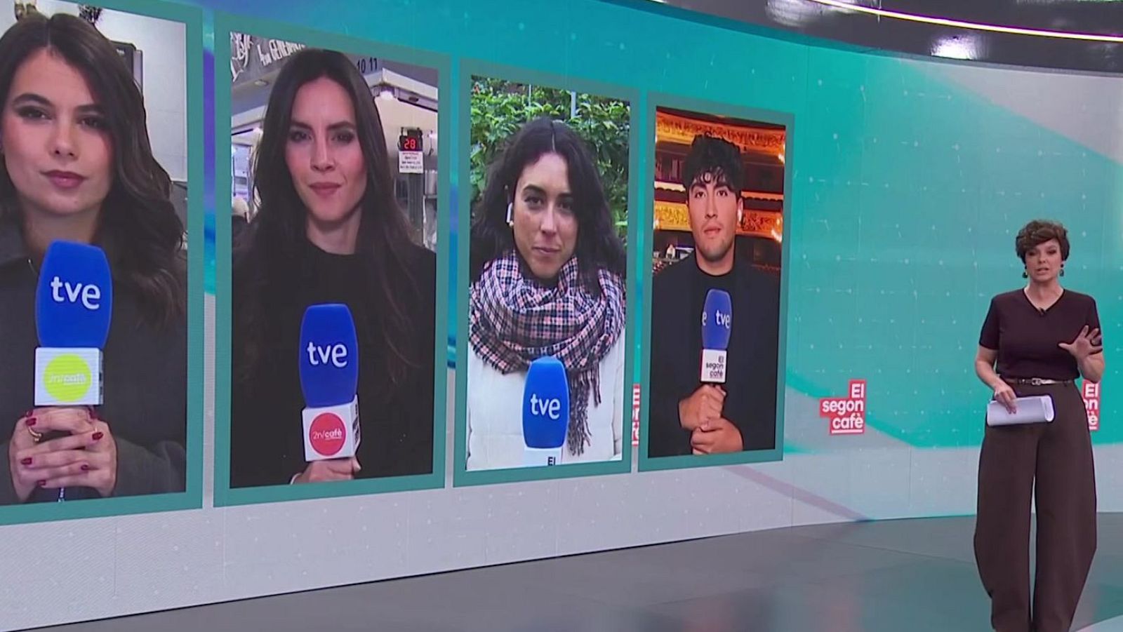 Cristina Villanueva, amb cabells castanys arrissats, presenta el programa des d'un plató. Porta una camiseta marró fosc, pantalons amples i un cinturó daurat, mentre sosté papers.