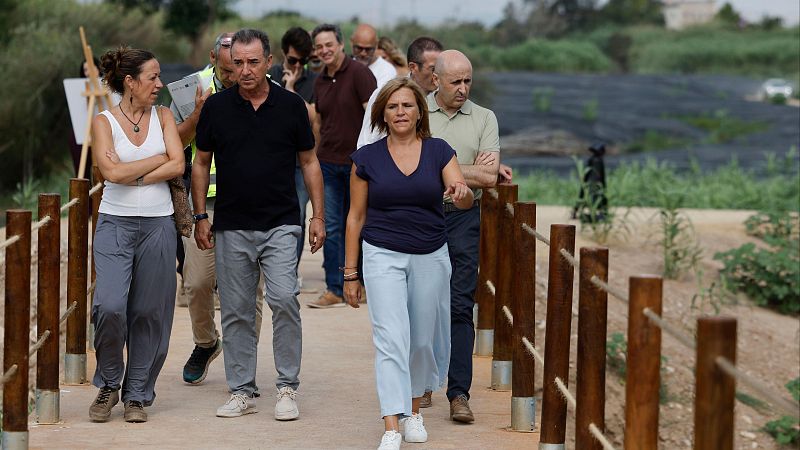 María Jesús Montero, José Luis Sanz y Juan Espadas caminan por un sendero natural con vegetación. Montero lidera el grupo, vestida de azul y blanco, mientras Sanz y Espadas la siguen.