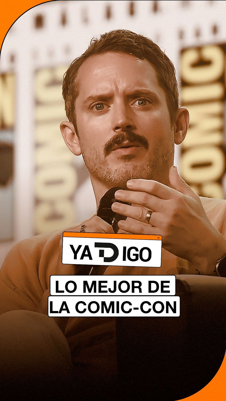 Primer plano del actor Elijah Wood hablando con un micrófono en una conferencia, con la palabra 'COMIC' al fondo y los rótulos 'YATDIGO' y 'LO MEJOR DE LA COMIC-CON'.