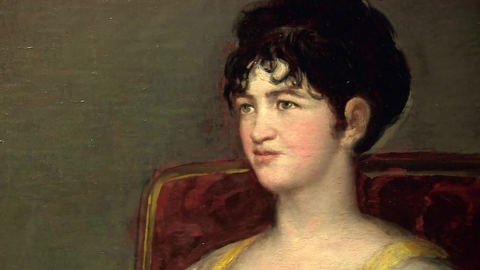 Primer plano del retrato al óleo de la marquesa de Villafranca pintado por Goya en 1804, mostrando su rostro sereno, peinado recogido y un sillón rojo.
