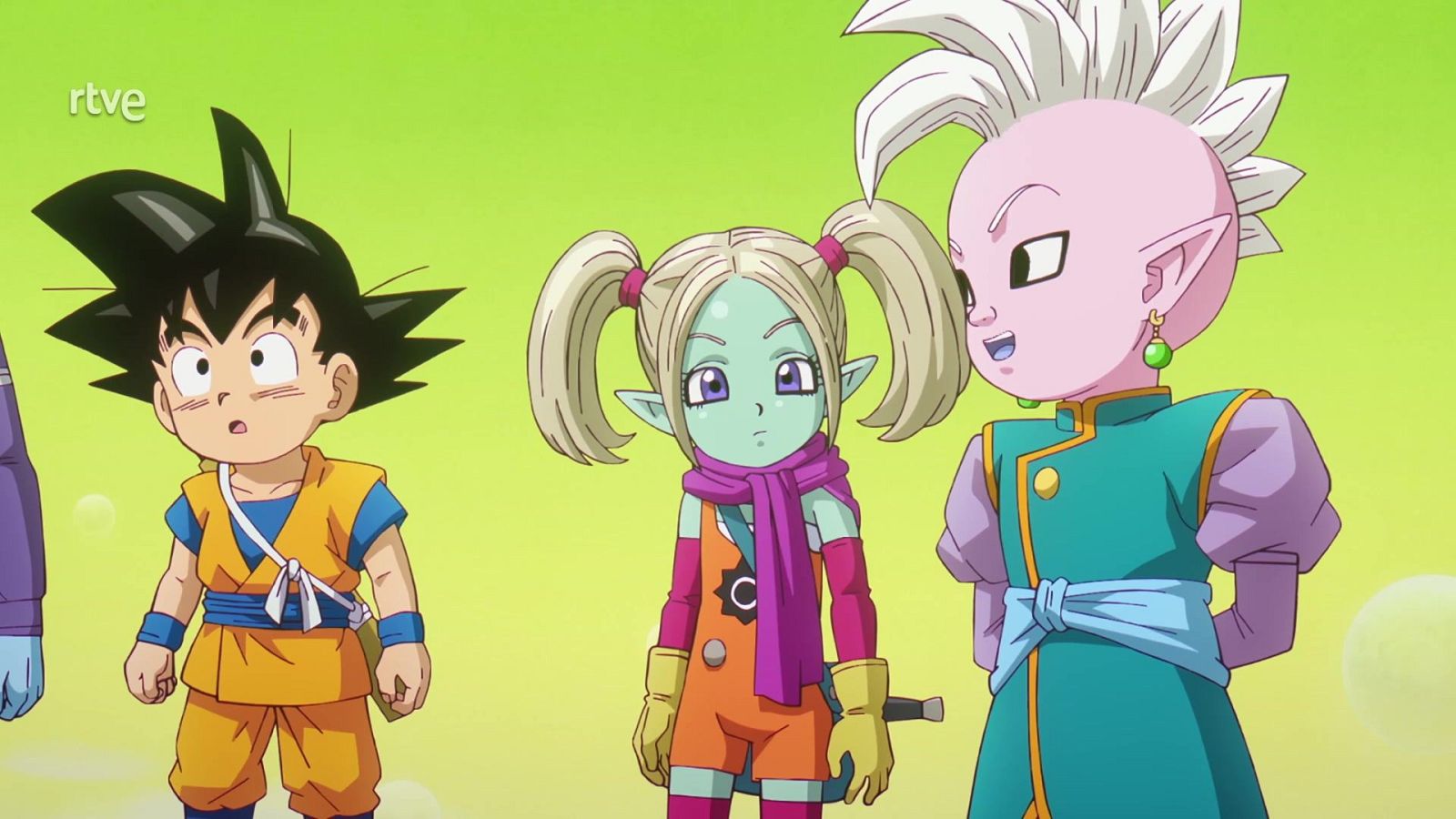 Tres personajes infantiles de Dragon Ball DAIMA: Goku con traje naranja, Panzy con coletas y bufanda, y Shin con túnica ceremonial, sobre fondo verde lima.
