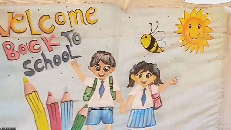 Pancarta escolar con texto en inglés, dos niños con uniforme y mochilas de la mano, lápices gigantes y un sol sonriente con una abeja.