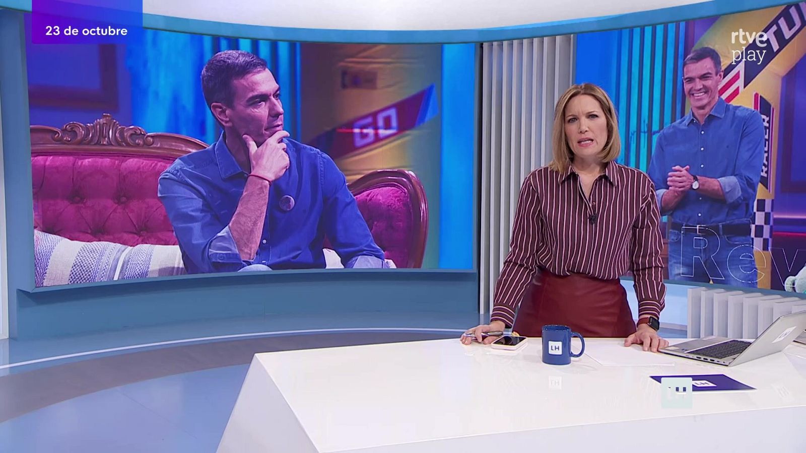 Silvia Intxaurrondo presenta el programa matinal en un plató con pantallas que muestran a Pedro Sánchez, junto a una mesa con un ordenador y una taza azul.