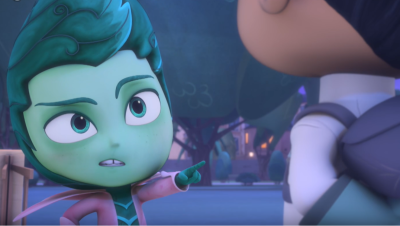 Newton Star de "PJ Masks" señala con el dedo índice a otro personaje en una escena nocturna. Newton tiene piel verde, cabello verde azulado y chaqueta rosa. El fondo es un paisaje urbano nocturno.